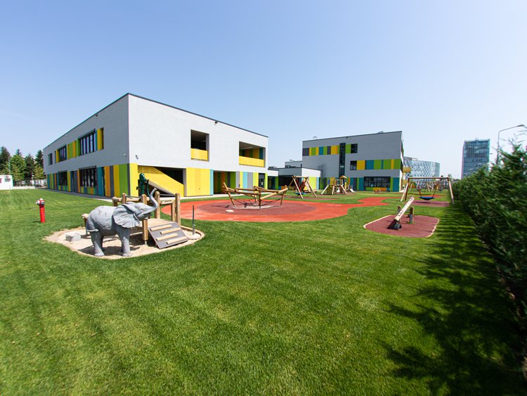 New children’s playground in front of a modern school building